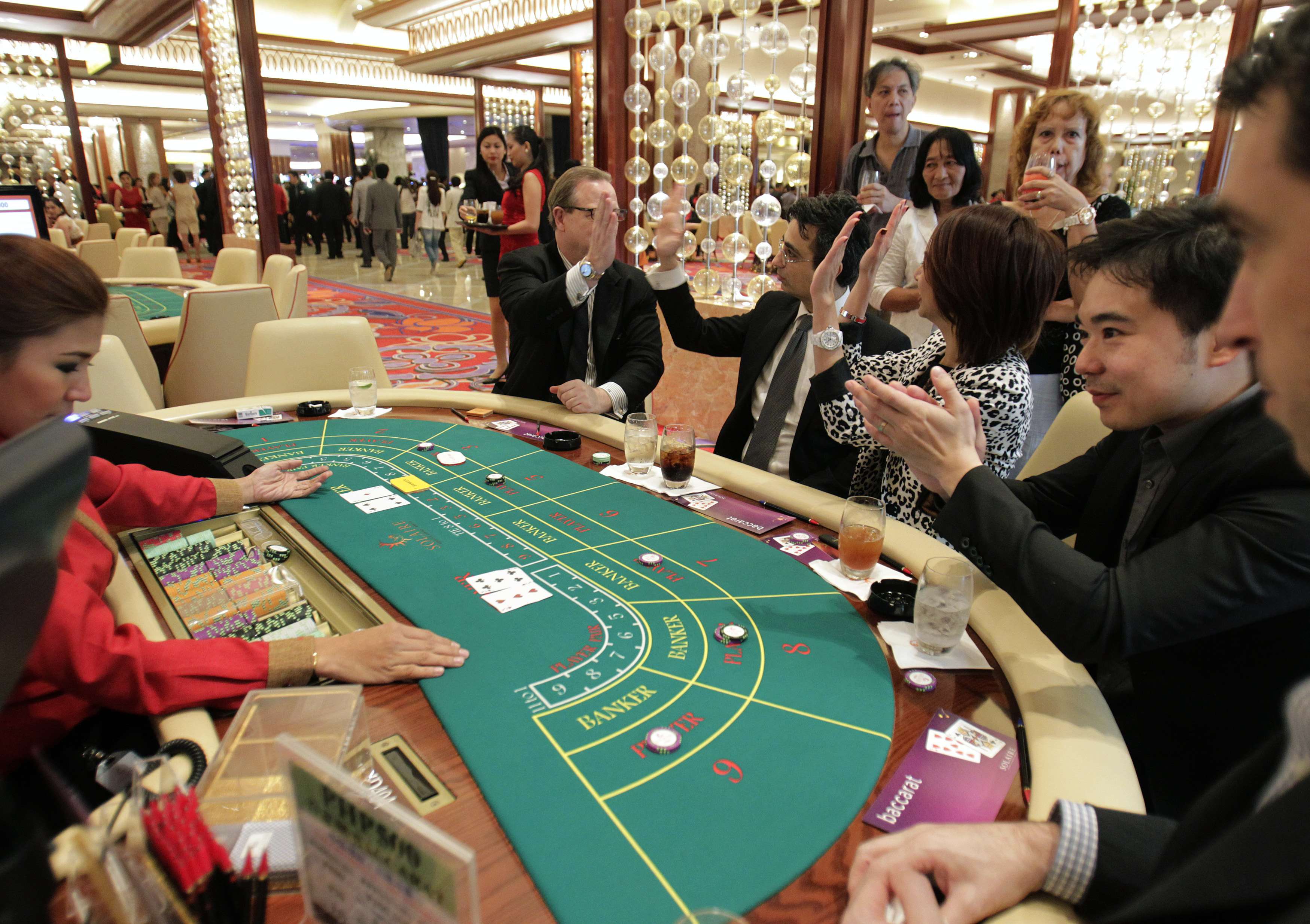 people playing baccarat in casino